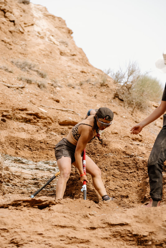 Christina Pondella trail building in Red Bull Rampage in a tank top and shorts with sunglasses on