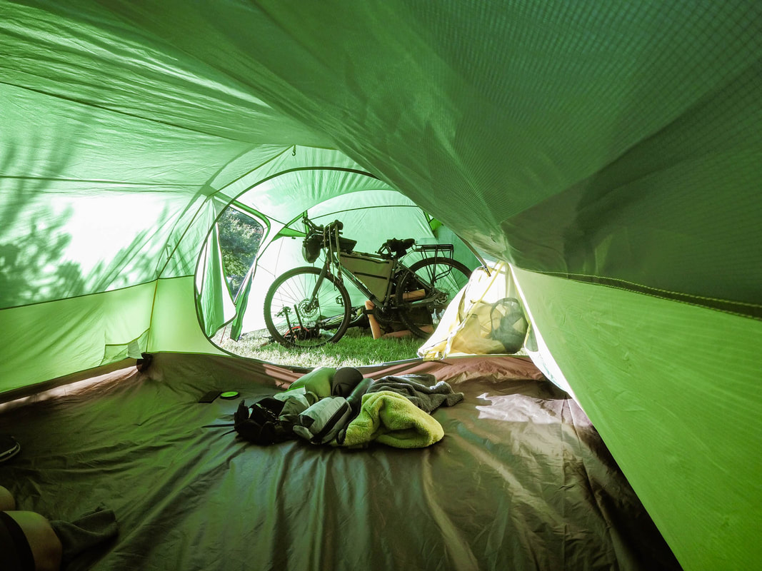 PicturePictureNatureHike Opalus4 four person tent set up on a bikepacking trip. The vestibule fit both our bikes undercover.